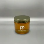 جار پلاستیکی 350 سی سی دهانه 88 شفاف حاوی عسل با درب فلزی طلایی